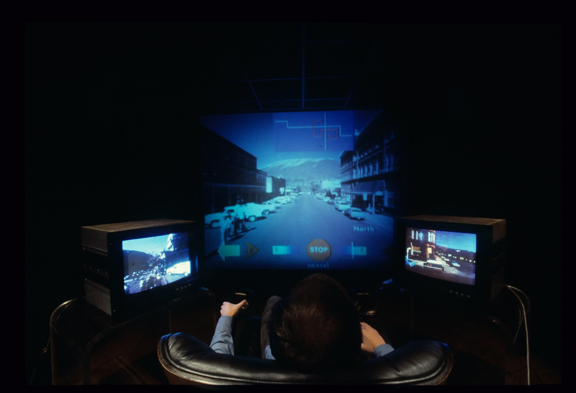 MIT's Aspen Movie Map (1978) assembled filmed streets, maps, historical images, controls, and navigational choices into a single explorable environment.